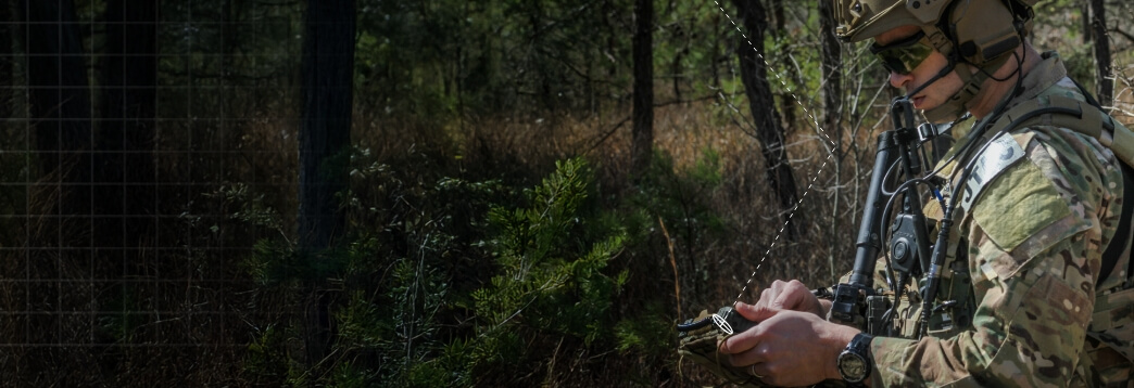 soldier using a device out in the field
